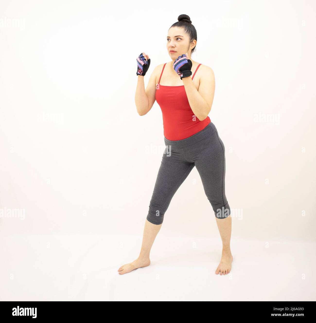 beautiful athletic asian woman in gray sportswear red top, practicing