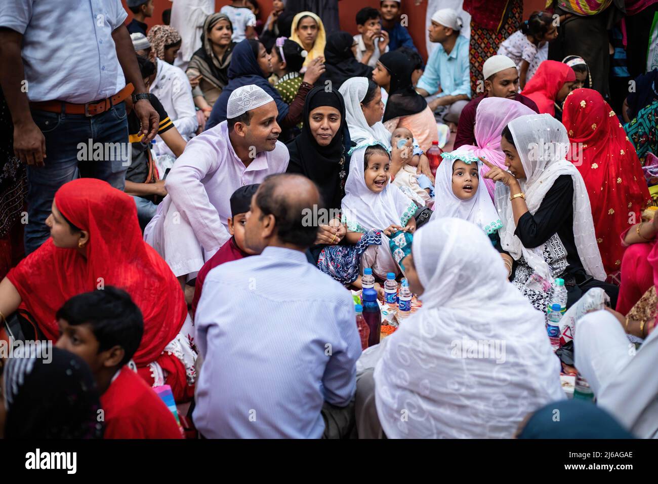 A Muslim family is seen breaking their fast at Iftar (Evening meal with which Muslims end their fast at sunset during the month of Ramadan) time at a mosque. (Photo by Jit Chattopadhyay / SOPA Images/Sipa USA) Stock Photo