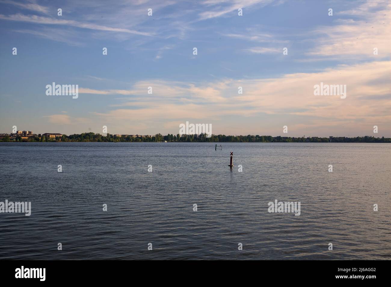 Lake at sunset with clouds in the sky Stock Photo - Alamy