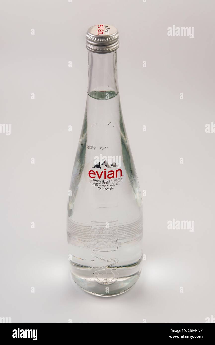 Evian natural spring mineral water with logo. French brand 750 ml elegant glass bottle against white background. Stock Photo