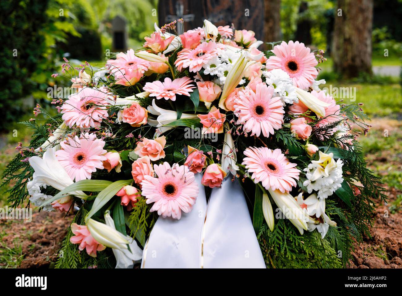 colorful pastel flowers on a grave after a funeral Stock Photo