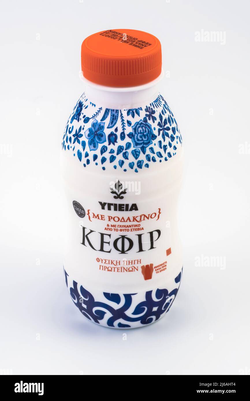 Greek kefir fermented milk drink with logo and Hellenic text, against white background. Stock Photo