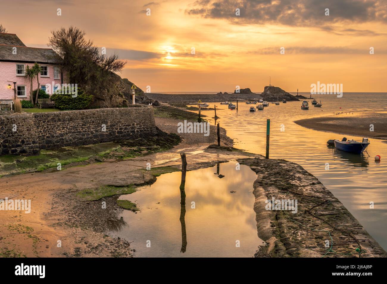 Bude, Cornwall, UK. Friday 29th April 2022. After a warm spring day in the South West of England, layers of cloud build on the horizon as the sun sets over the breakwater at Bude in North East Cornwall. Terry Mathews. Alamy Live News. Stock Photo