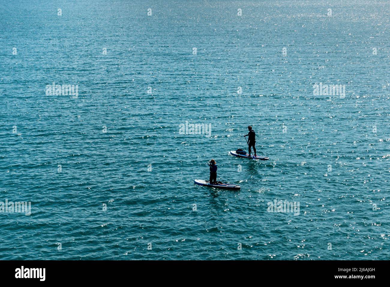 Paddleboarders,Alone,Out at Sea,Sunshine,Breezy,Paddleboarding,Paddleboard,Paddleboards, Stock Photo