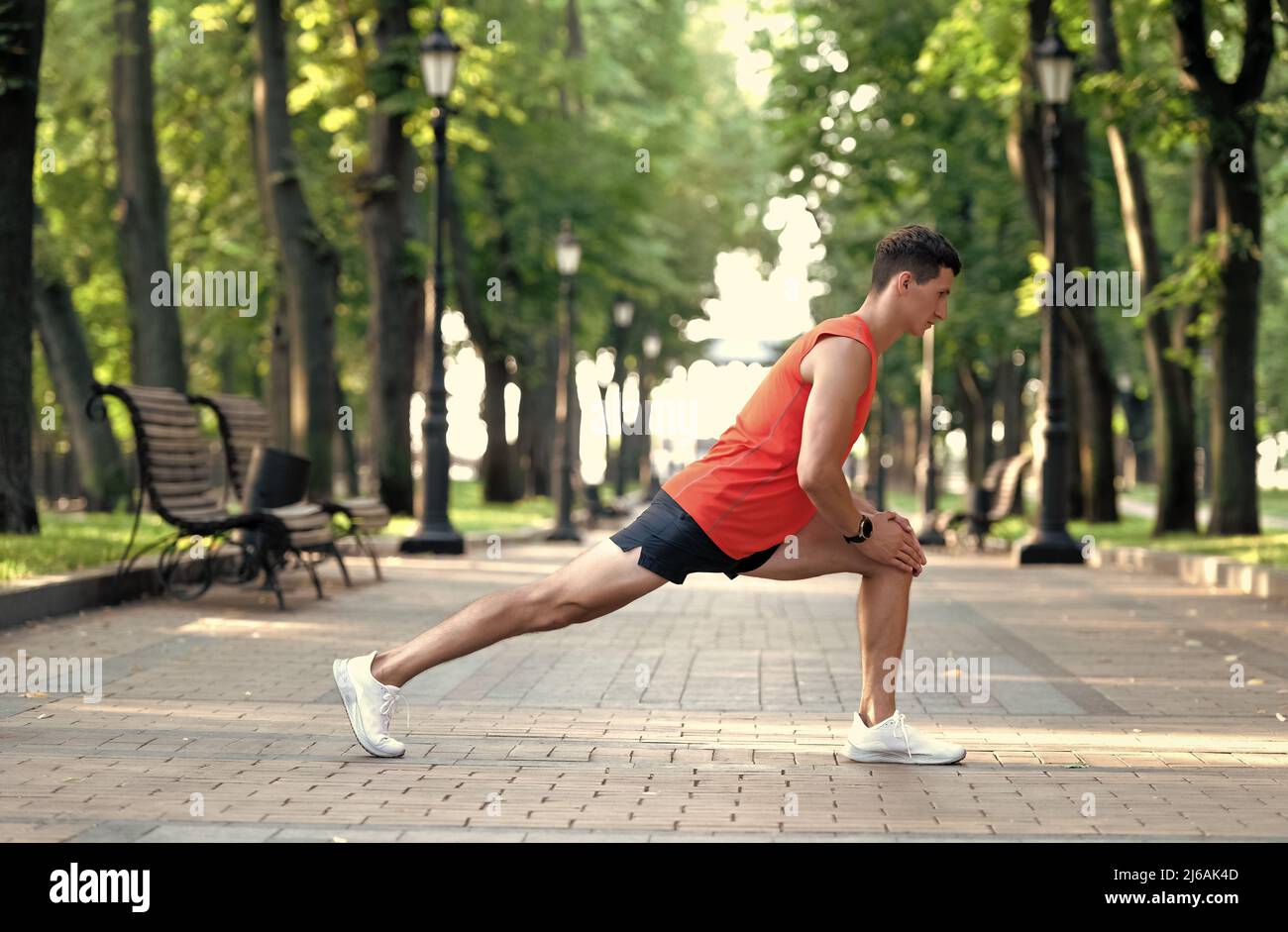 Get warmed up before workout. Man take warmup. Sportsman hold lunge position. Warmup exercises Stock Photo