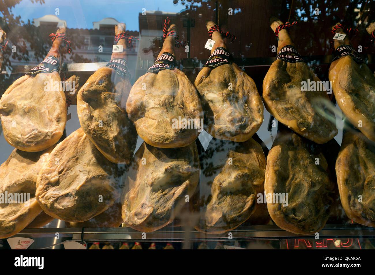 Cured Ham hanging in Store Window, Madrid, Spain Stock Photo