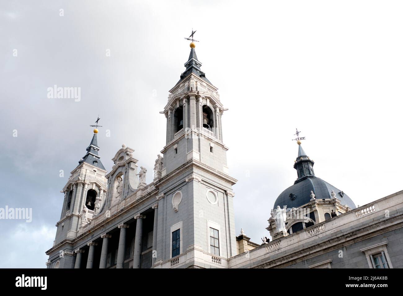 Low Angle View of Bell Towers, Almudena Cathedral, against Gray Sky, Madrid, Spain Stock Photo
