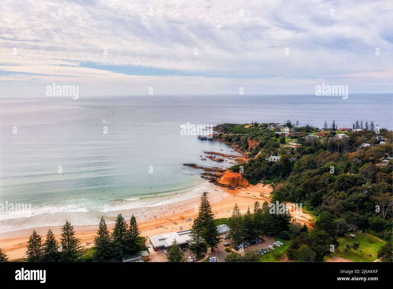 Sandy beach waterfront in Tathra coastal town of Australia on Sapphire coast - aerial seascape. Stock Photo