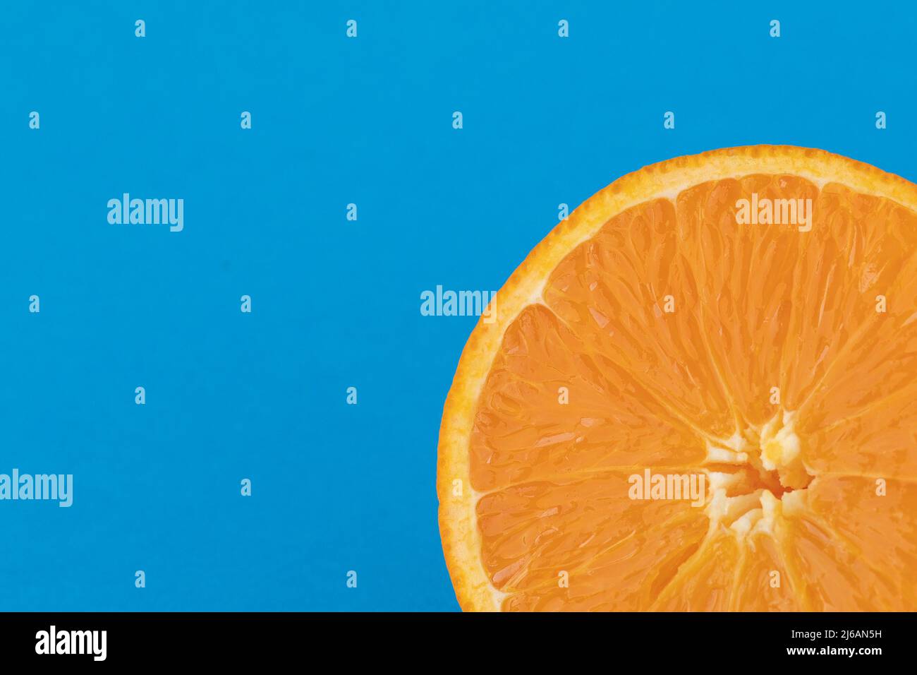 Halved navel orange on solid blue background Stock Photo