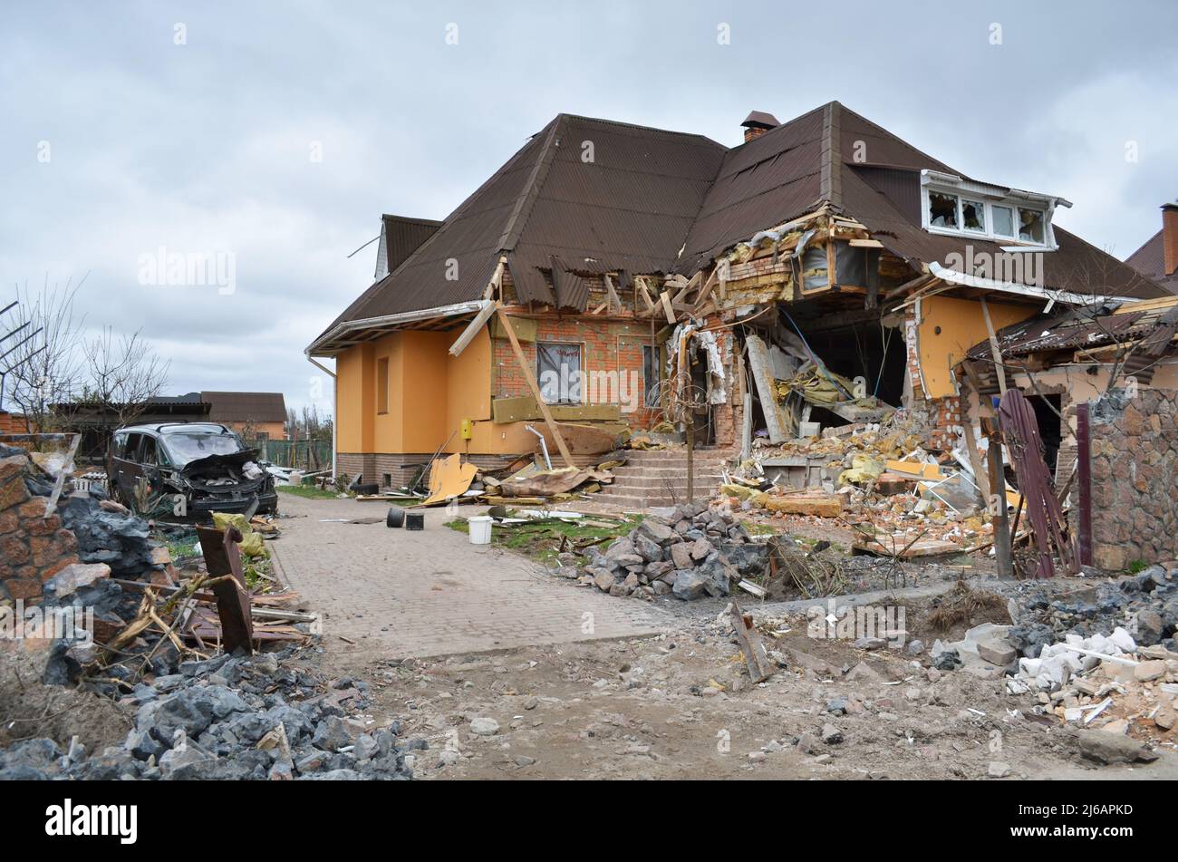 Dmytrivka, Kyiv region, Ukraine - Apr 13, 2022: Destroyed private house following firing from a tank of Russian army. War of Russia against Ukraine. Stock Photo