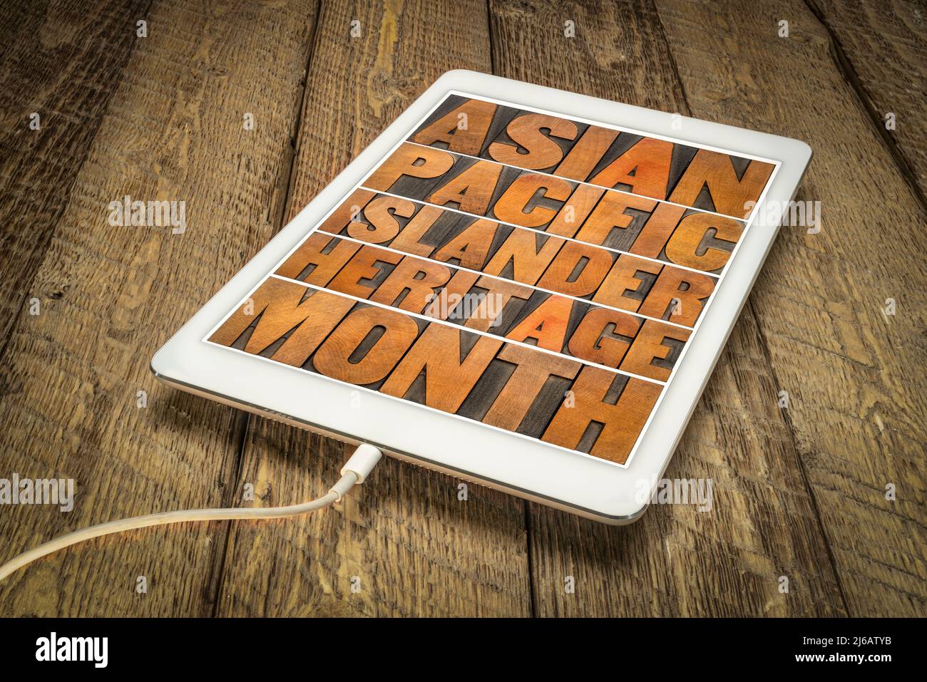 Asian Pacific Islander Heritage Month - word abstract in vintage letterpress wood type on a digital tablet, reminder of cultural event Stock Photo