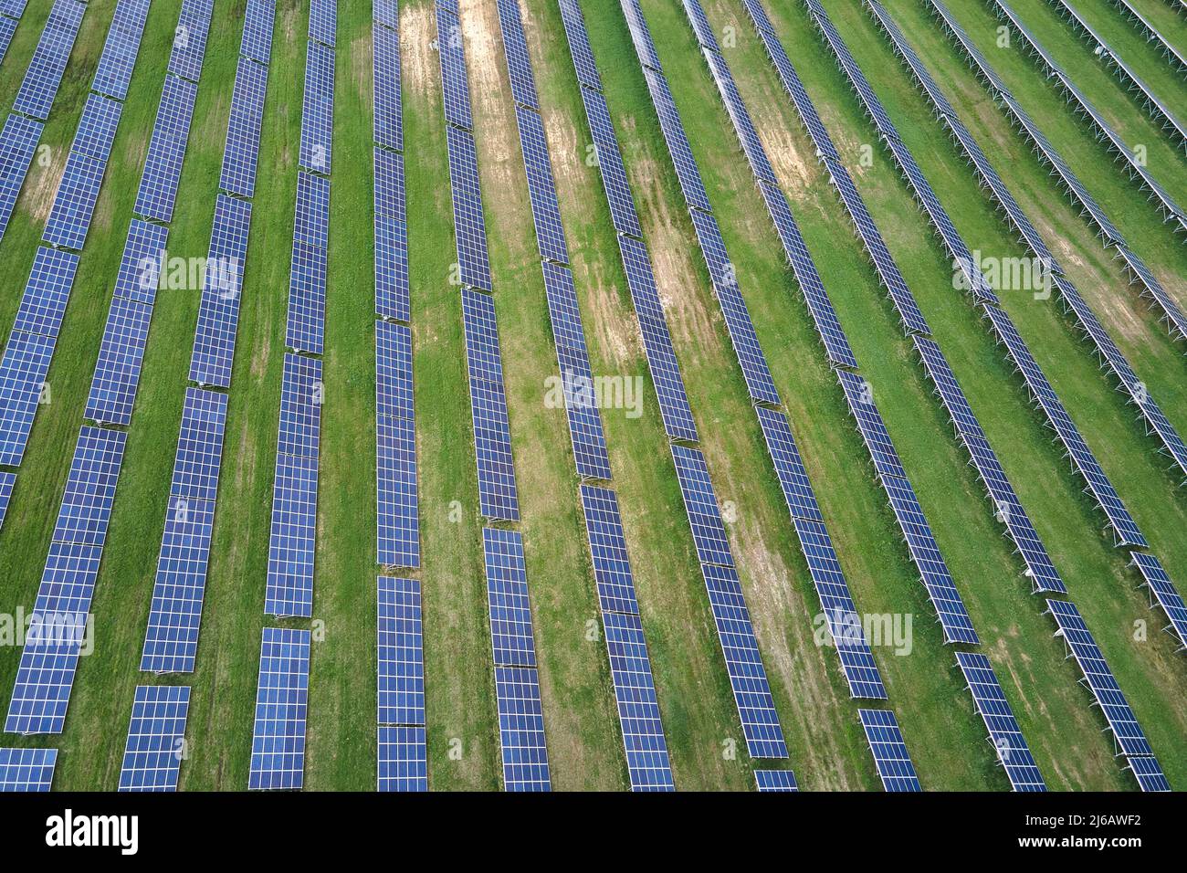 Aerial view of big sustainable electric power plant with many rows of