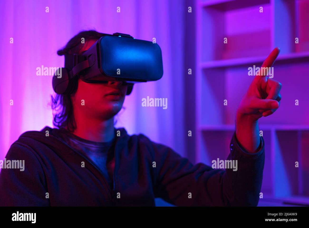 Metaverse technology concept, Man wear VR goggles and pointing to touch