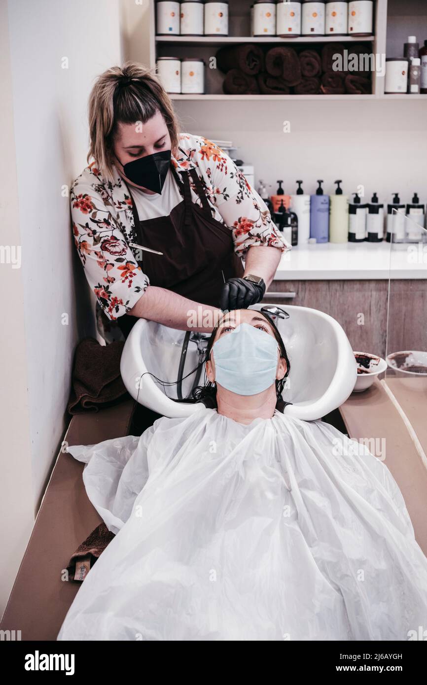 beautiful young woman enjoying a head massage with her eyes closed
