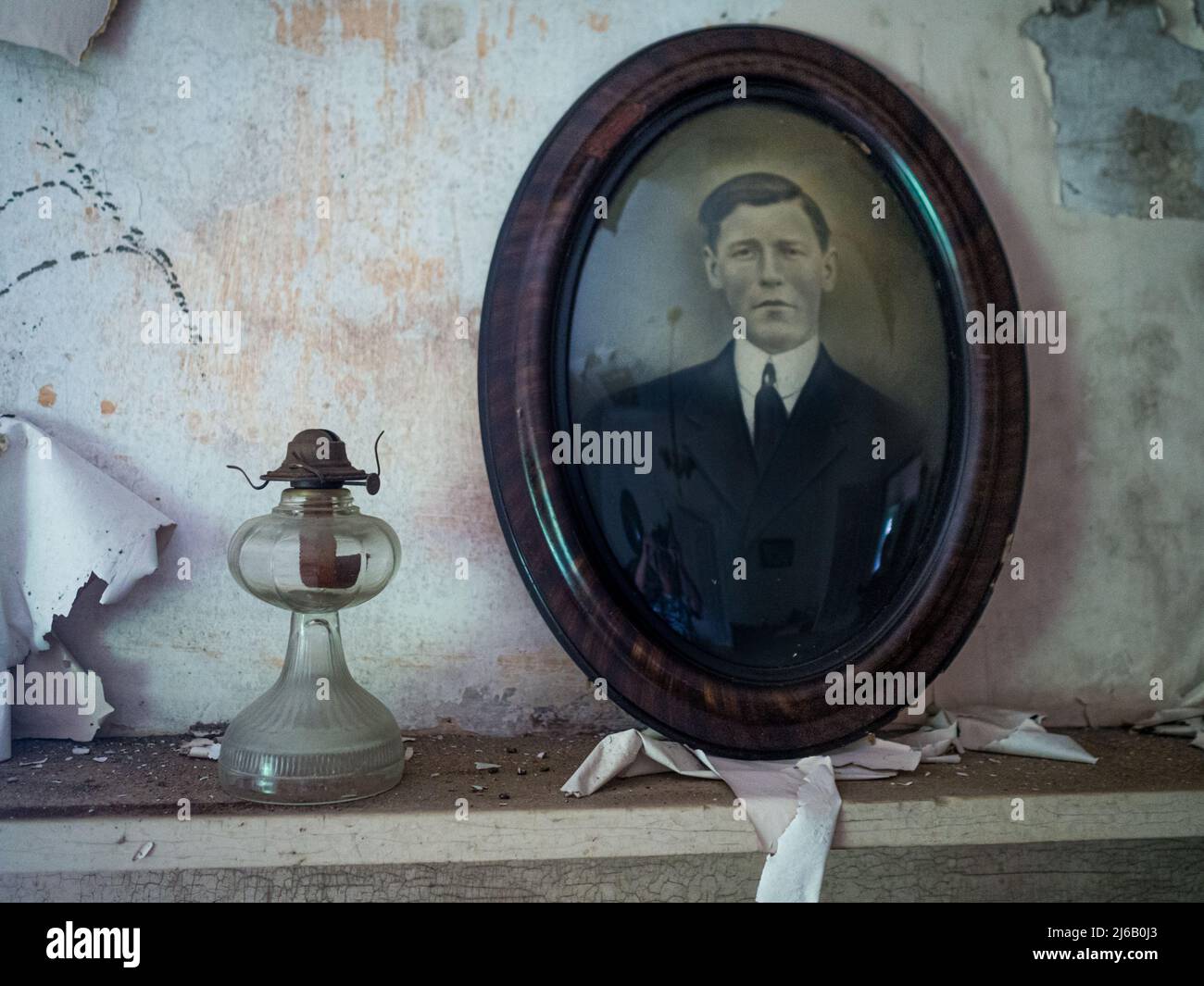 An old photograph in a wooden frame inside an abandoned house Stock Photo