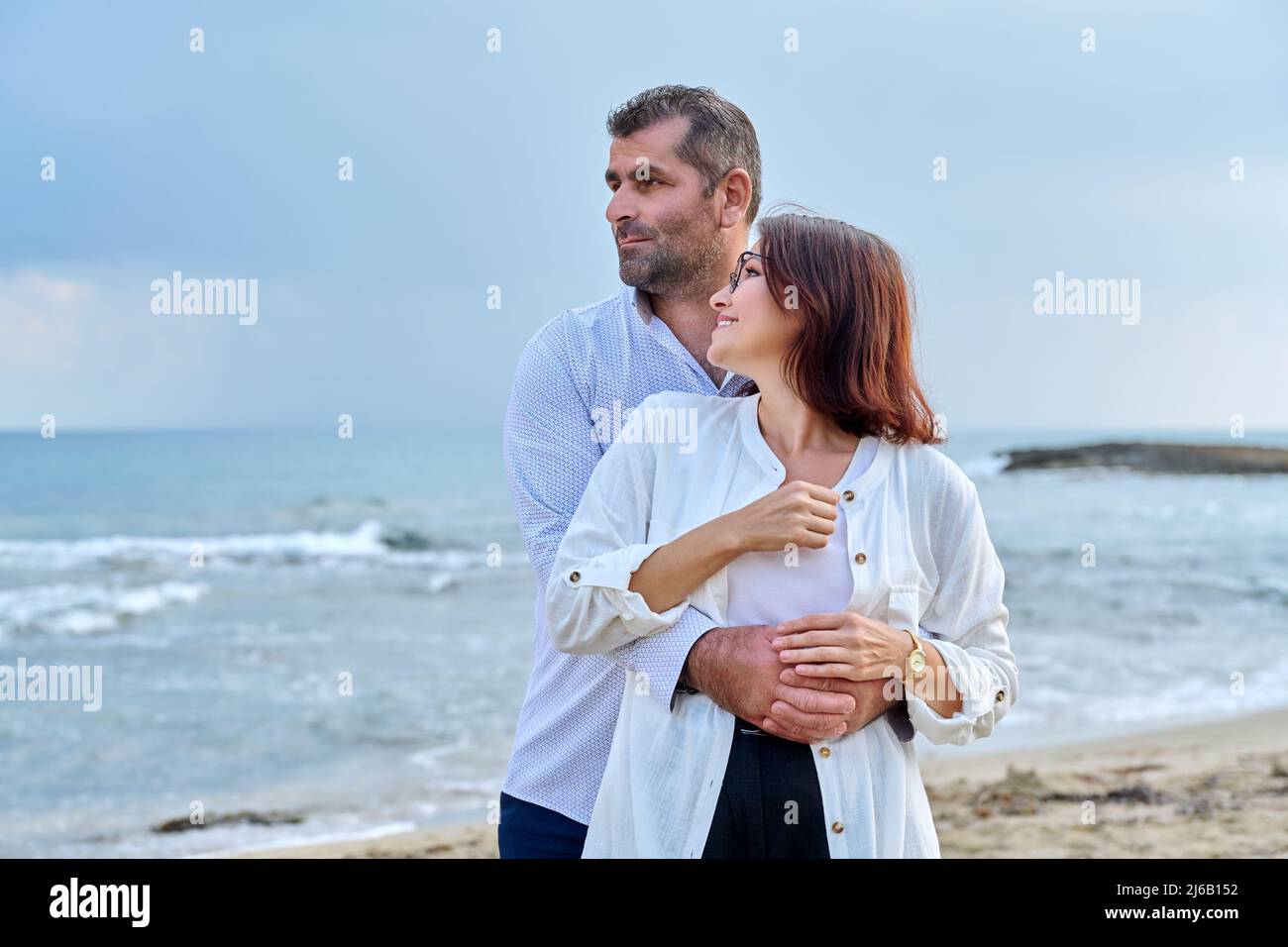 Outdoor portrait of mature couple hugging on the seashore Stock Photo