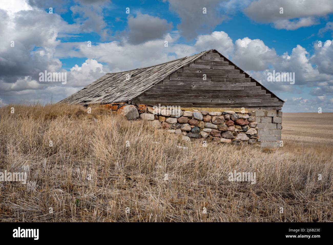 A historic dugout house that was converted into a barn in a field in Saskatchewan Stock Photo