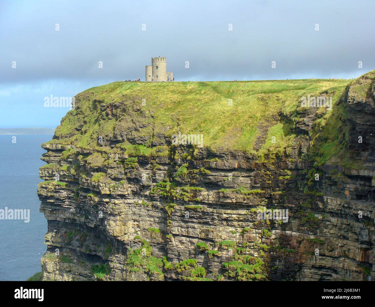 colorful ocean views, green grassy rocks, rocks and blue water. The ...