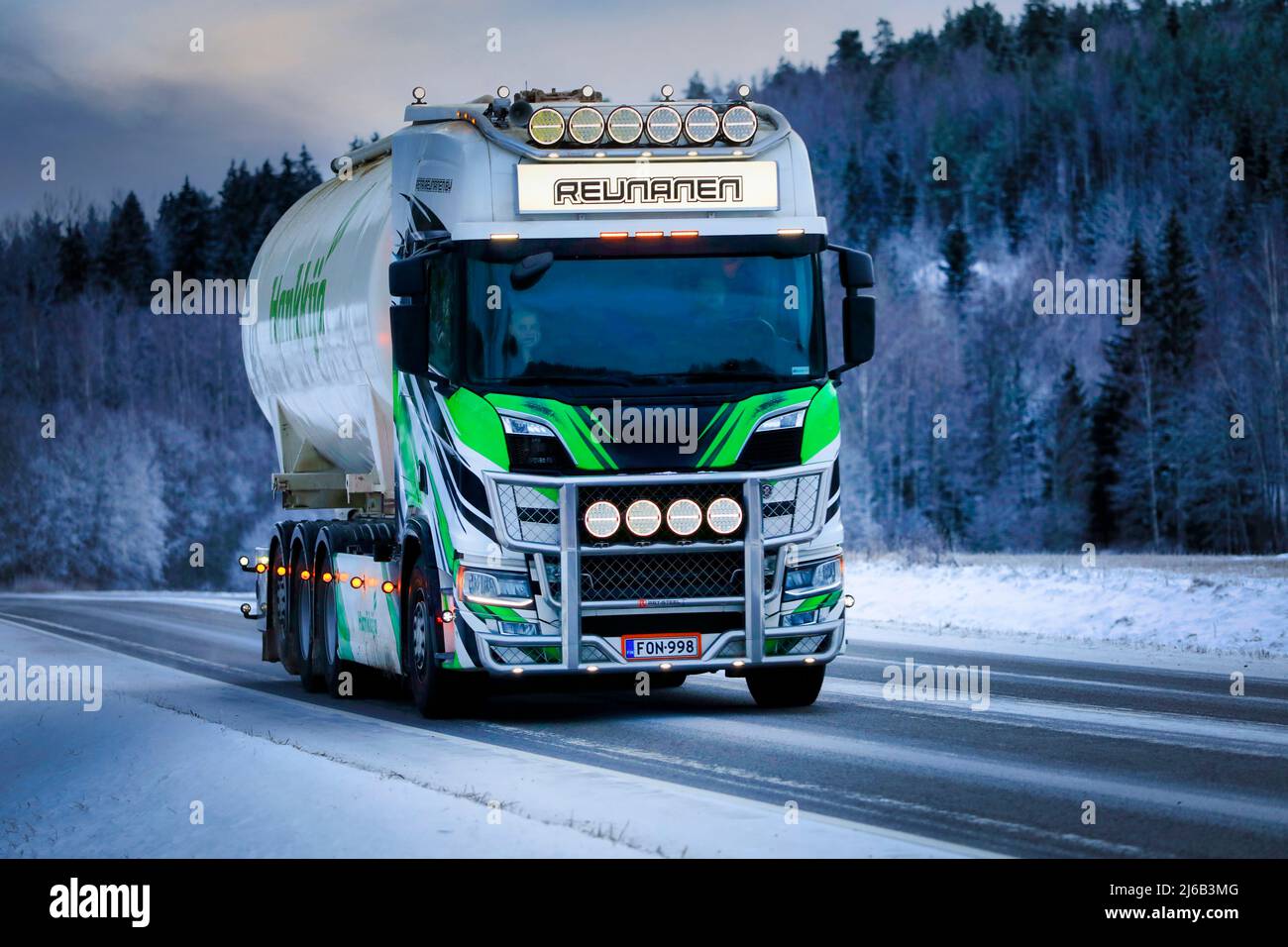 Beautifully customised Scania bulk transport truck Petri Reunanen Oy on road at winter dusk. Salo, Finland. December 28, 2021 Stock Photo