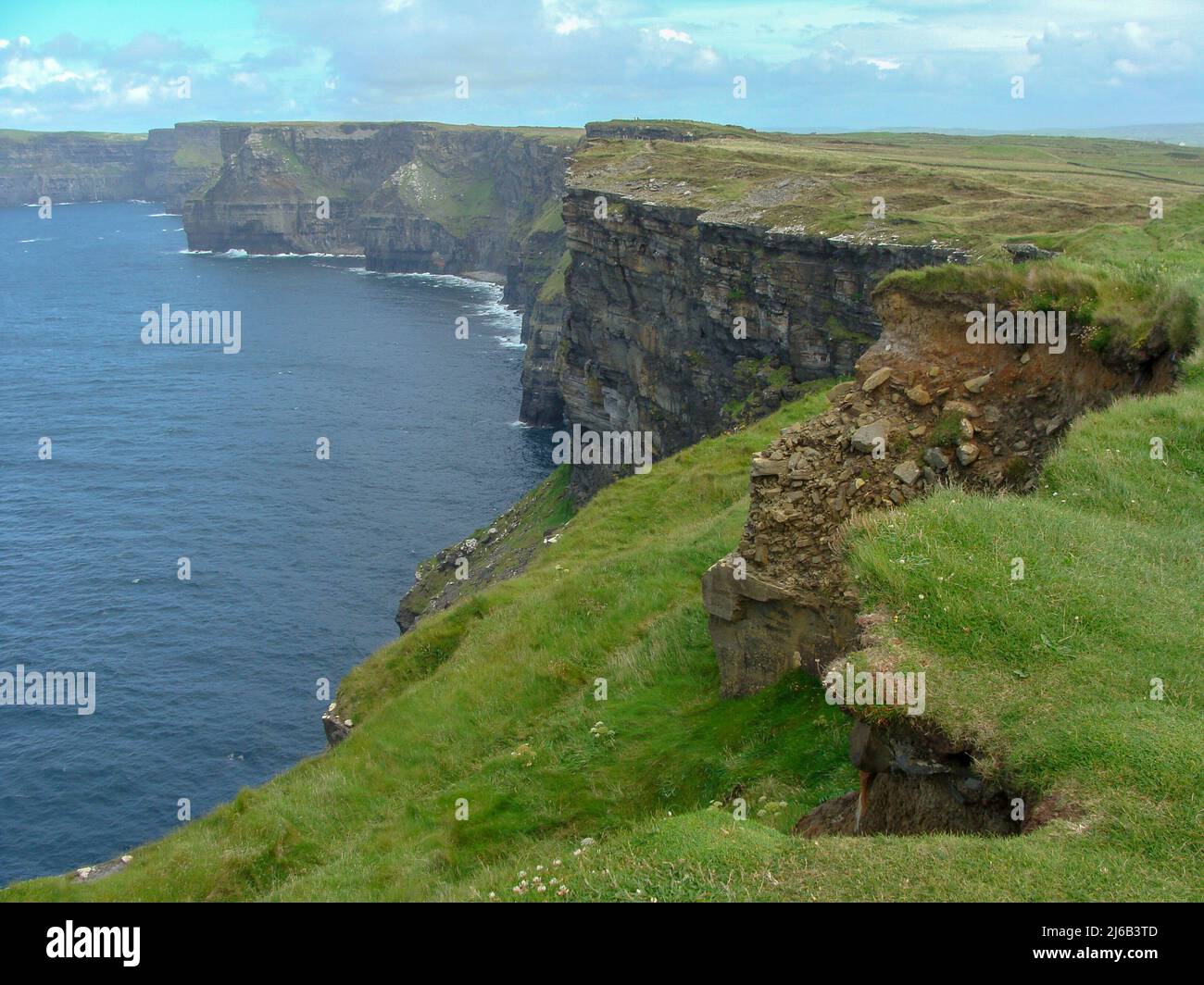 colorful ocean views, green grassy rocks, rocks and blue water. The ...