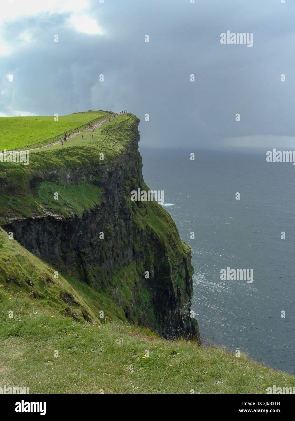 colorful ocean views, green grassy rocks, rocks and blue water. The ...
