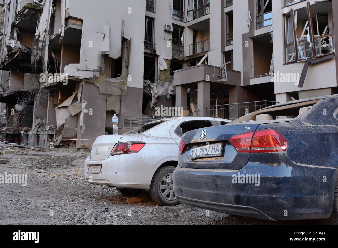 Cars were destroyed near the damaged apartment building in central Kyiv following the Russian