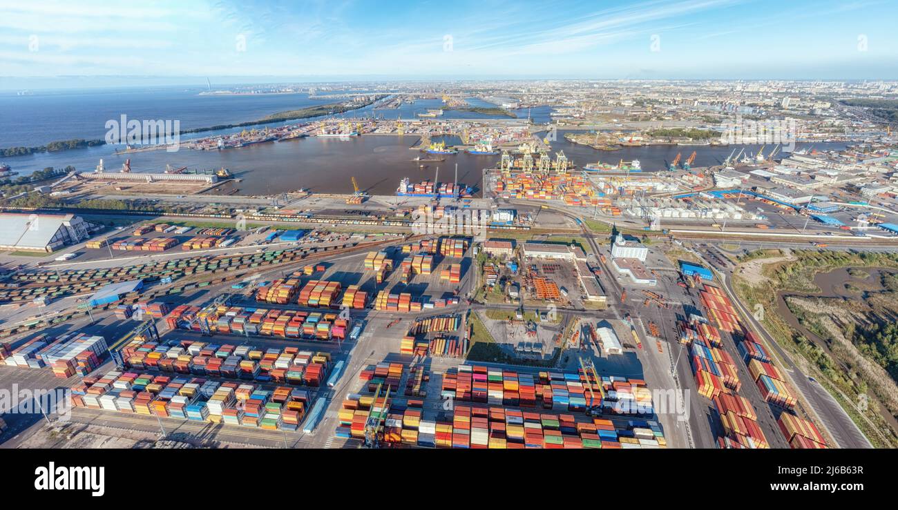 Large panoramic aerial view on sea port with cargo containers in Saint Petersburg, Russia against distant city Stock Photo