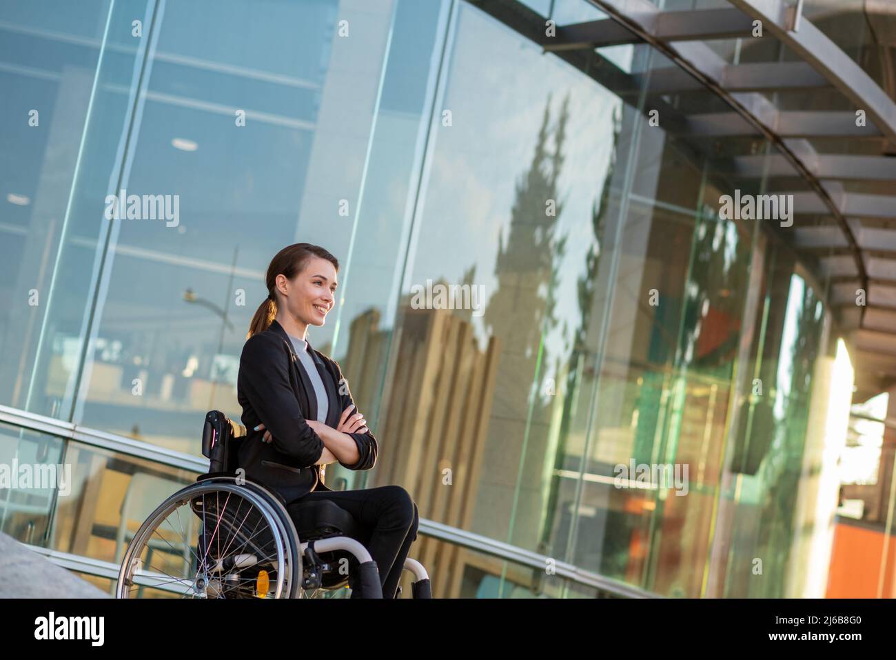 Businesswoman with a disability who uses a wheelchair Stock Photo