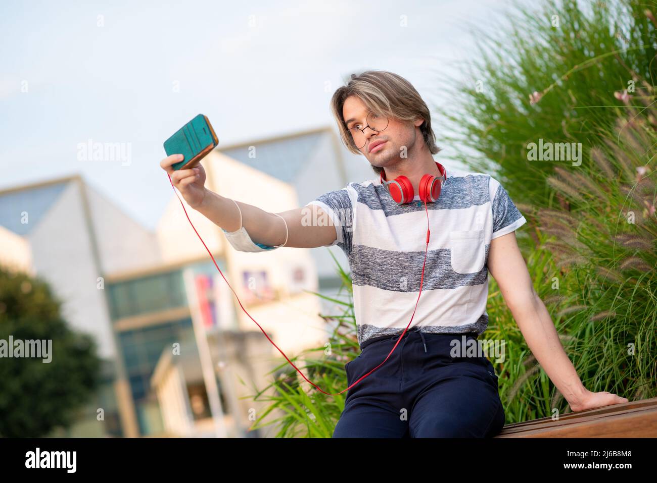 Young gay man taking selfie with mobile phone Stock Photo
