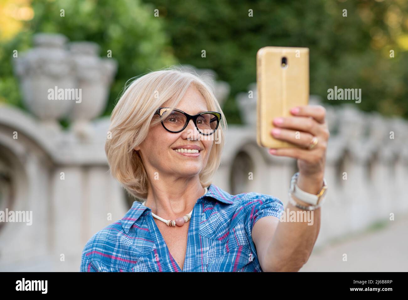 Beautiful senior woman taking a selfie Stock Photo