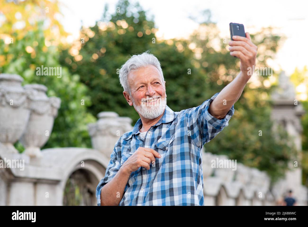 Handsome senior man taking a selfie Stock Photo