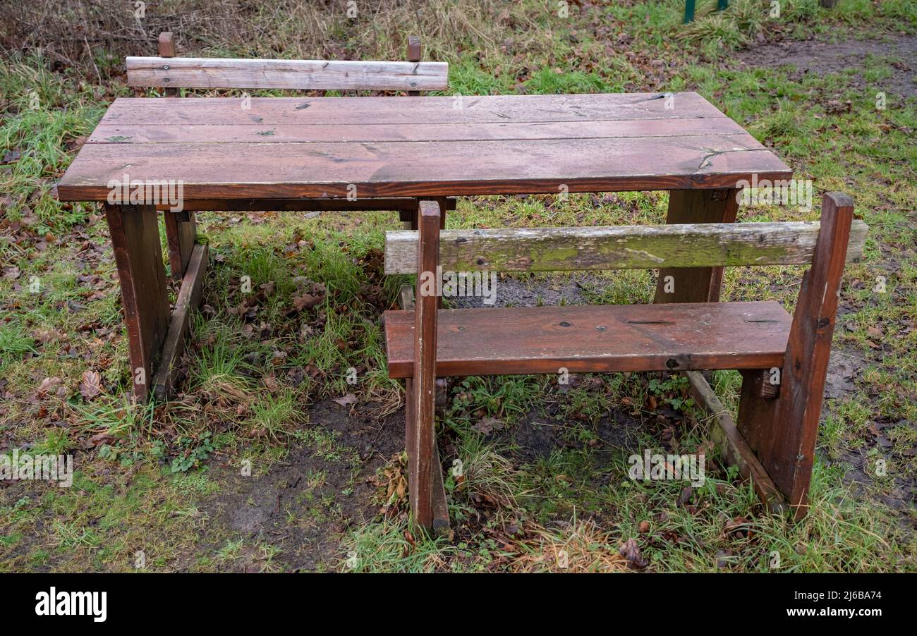 Close up of a wooden picnic table with space for wheelchair and disabled access Stock Photo