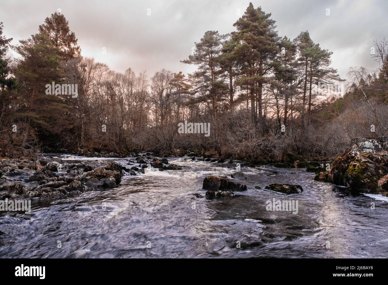 The confluence of the Water of Deugh and Polmaddy Burn at Sunset at Dundeugh, Carsphairn, Scotland Stock Photo