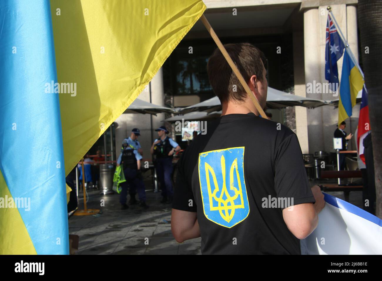 Sydney, Australia. 30th April 2022. Weekly walking rally from Martin Place to Circular Quay to raise awareness about the war in Ukraine and show support for Ukraine. Pictured: The Ukrainian coat of arms on a man's t-shirt. Credit: Richard Milnes/Alamy Live News Stock Photo