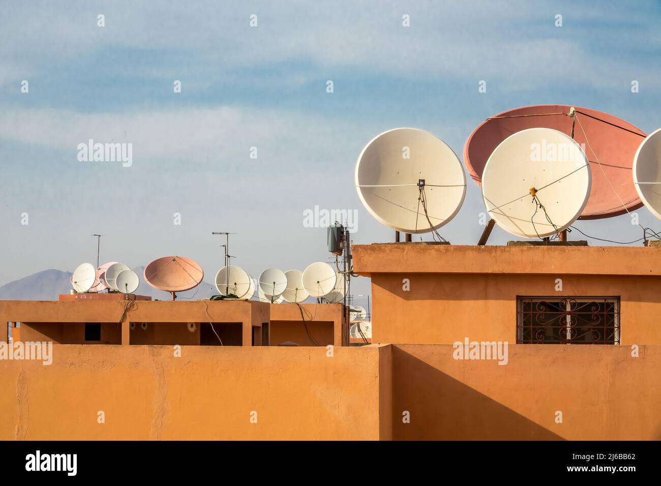 Many dish antennas on rooftops in a town in Morocco Stock Photo