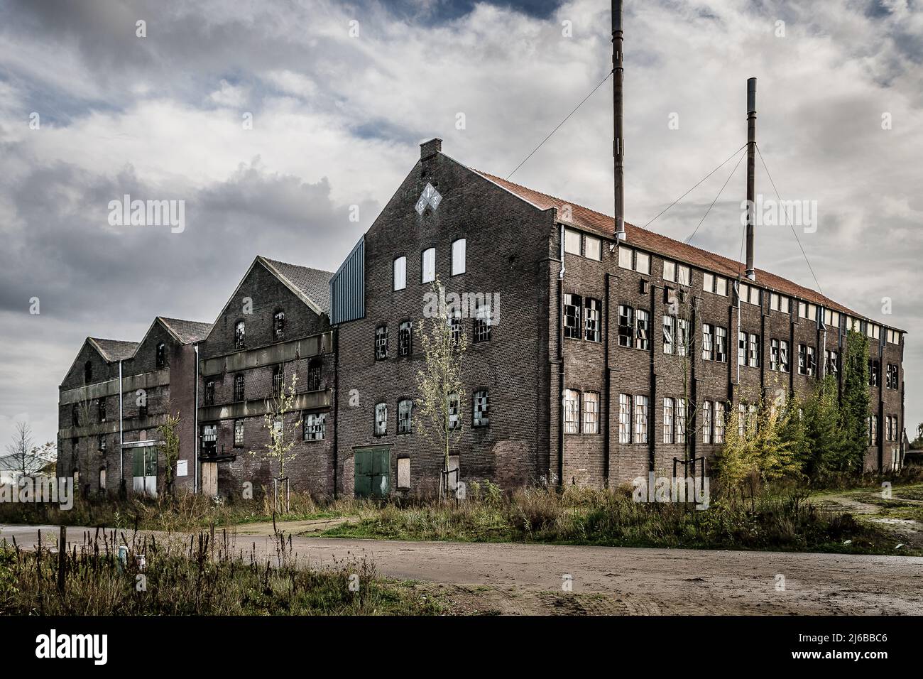 old and obsolete factory with weatherd walls and broken shattered
