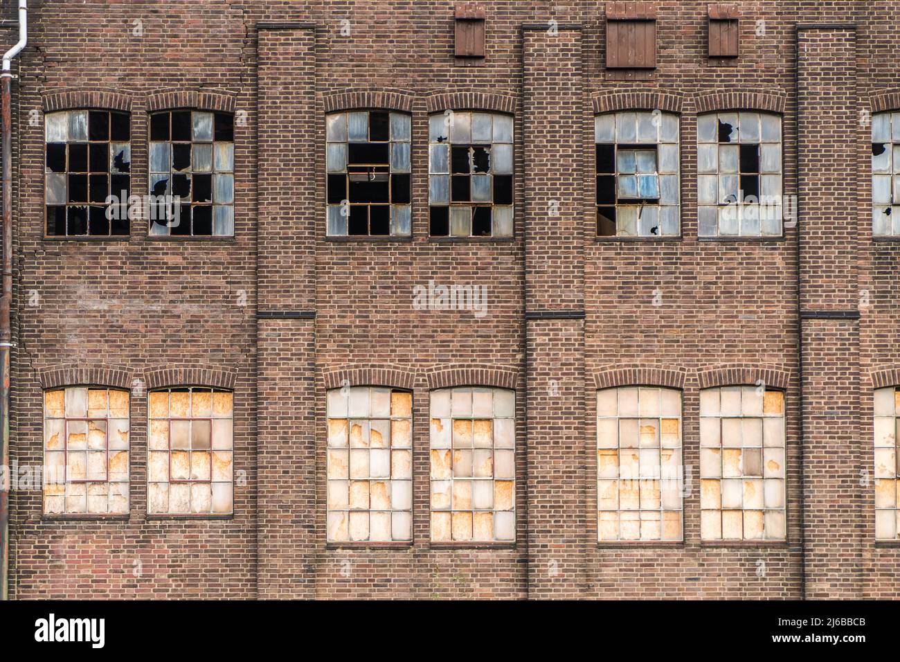 old and obsolete factory with weatherd walls and broken shattered