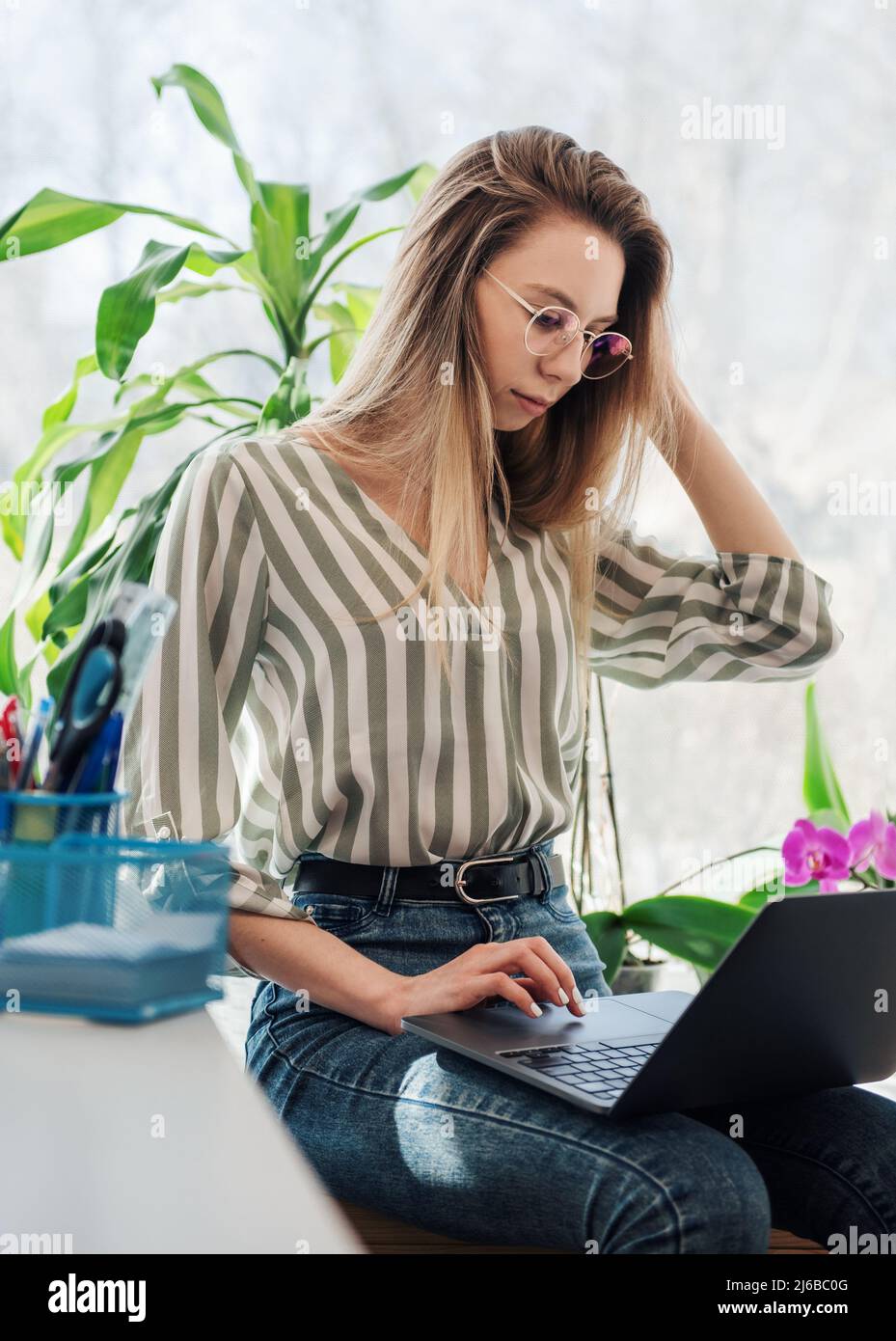Young woman working on a computer in her office Stock Photo - Alamy