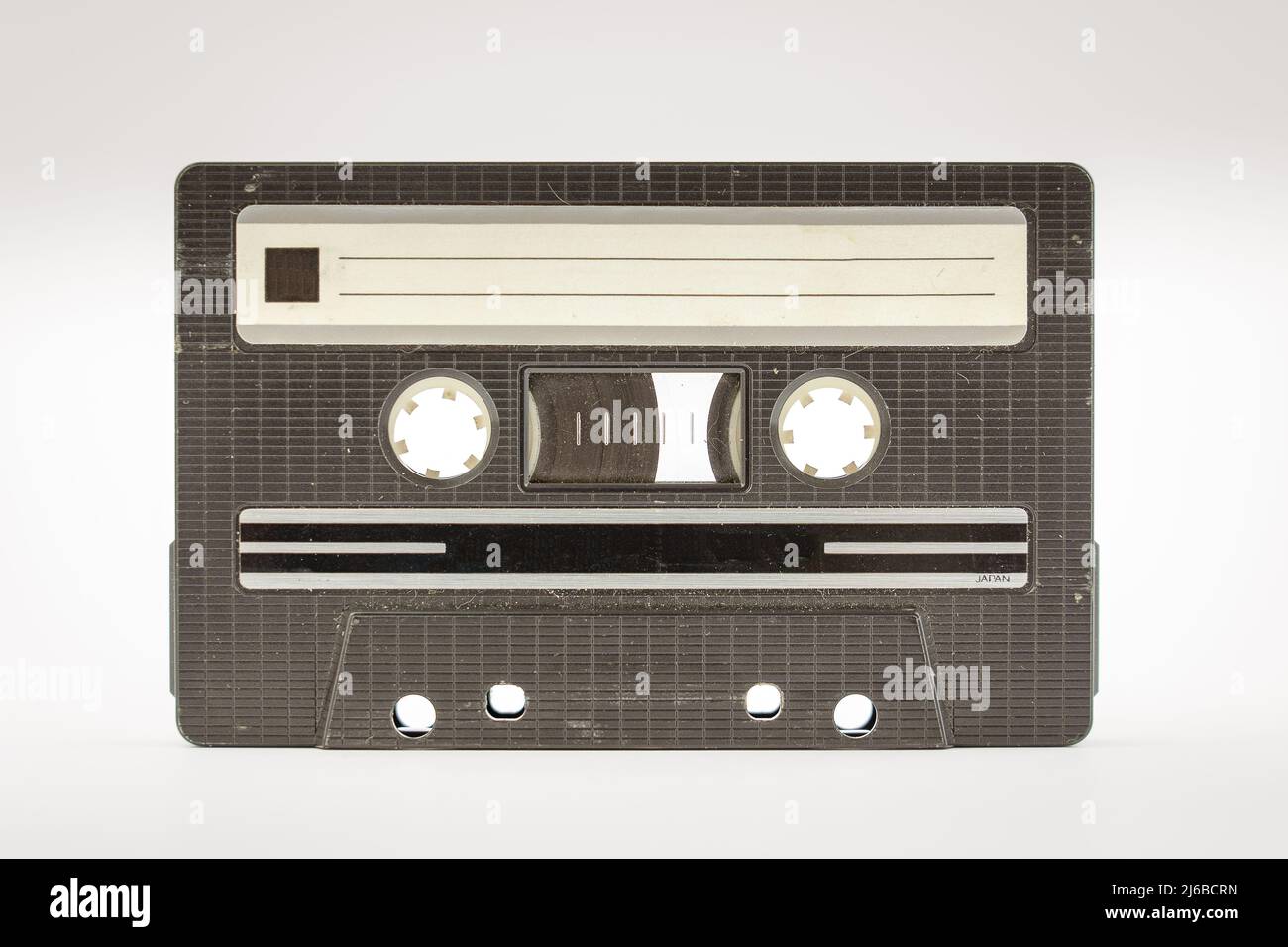 Old vintage cassette tape that is scratched and full of dust particles Stock Photo