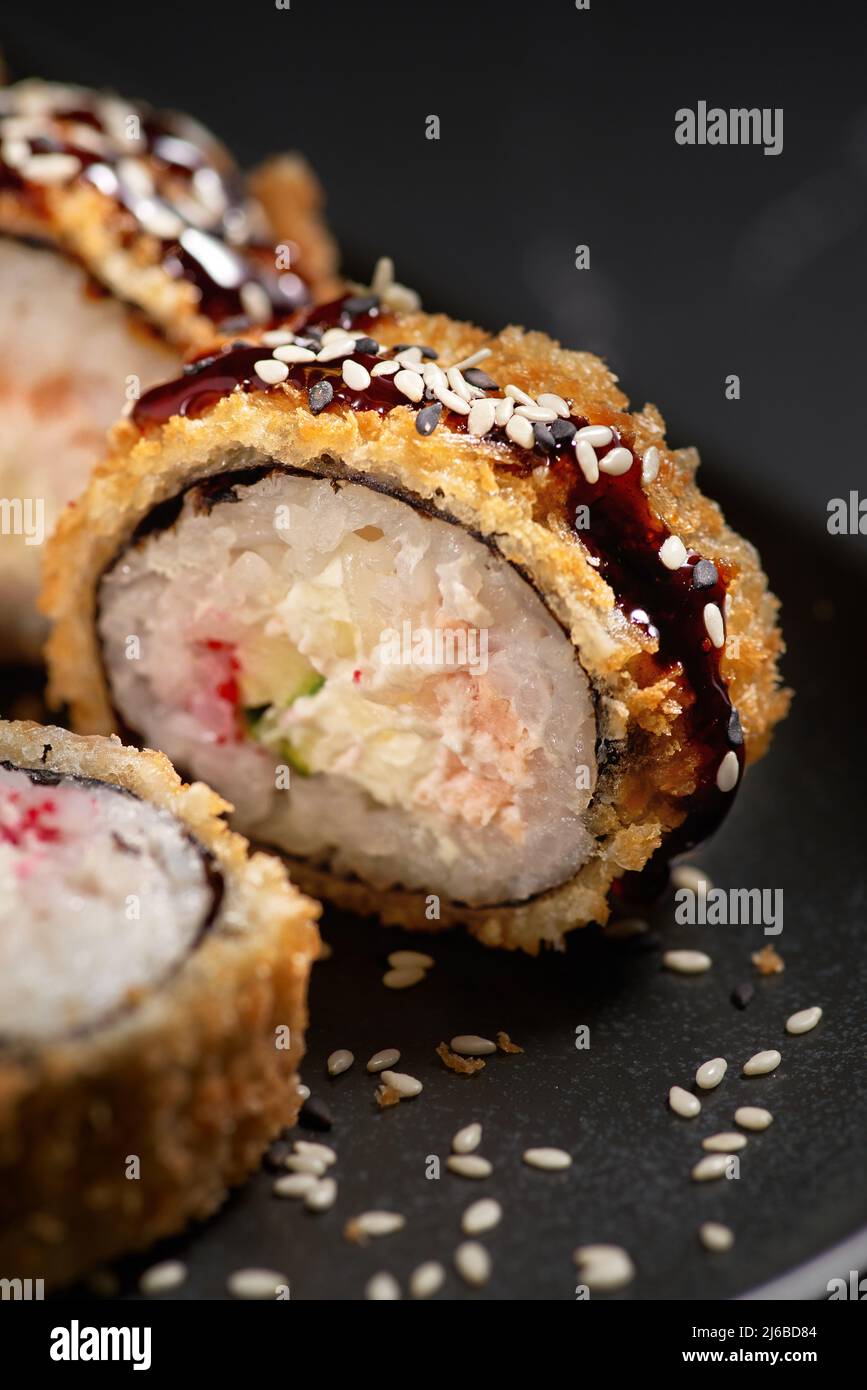Hot fried sushi rolls and maki with crab, cream cheese, avocado and wasabi  on black stone, selective focus. Japanese kitchen Stock Photo - Alamy