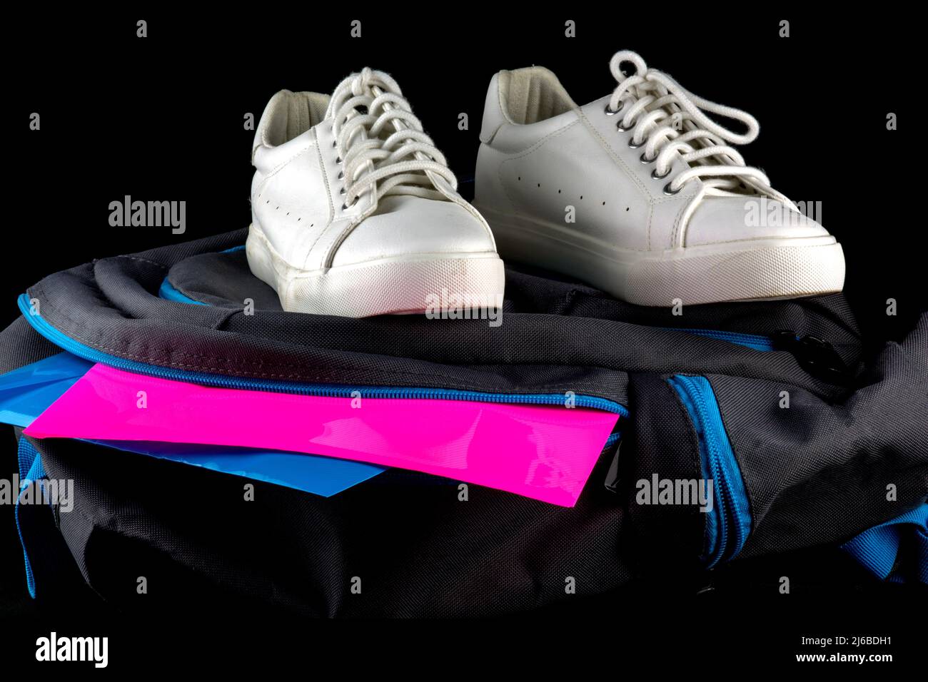 Closeup view of school shoes with school bag and files on a black background Stock Photo