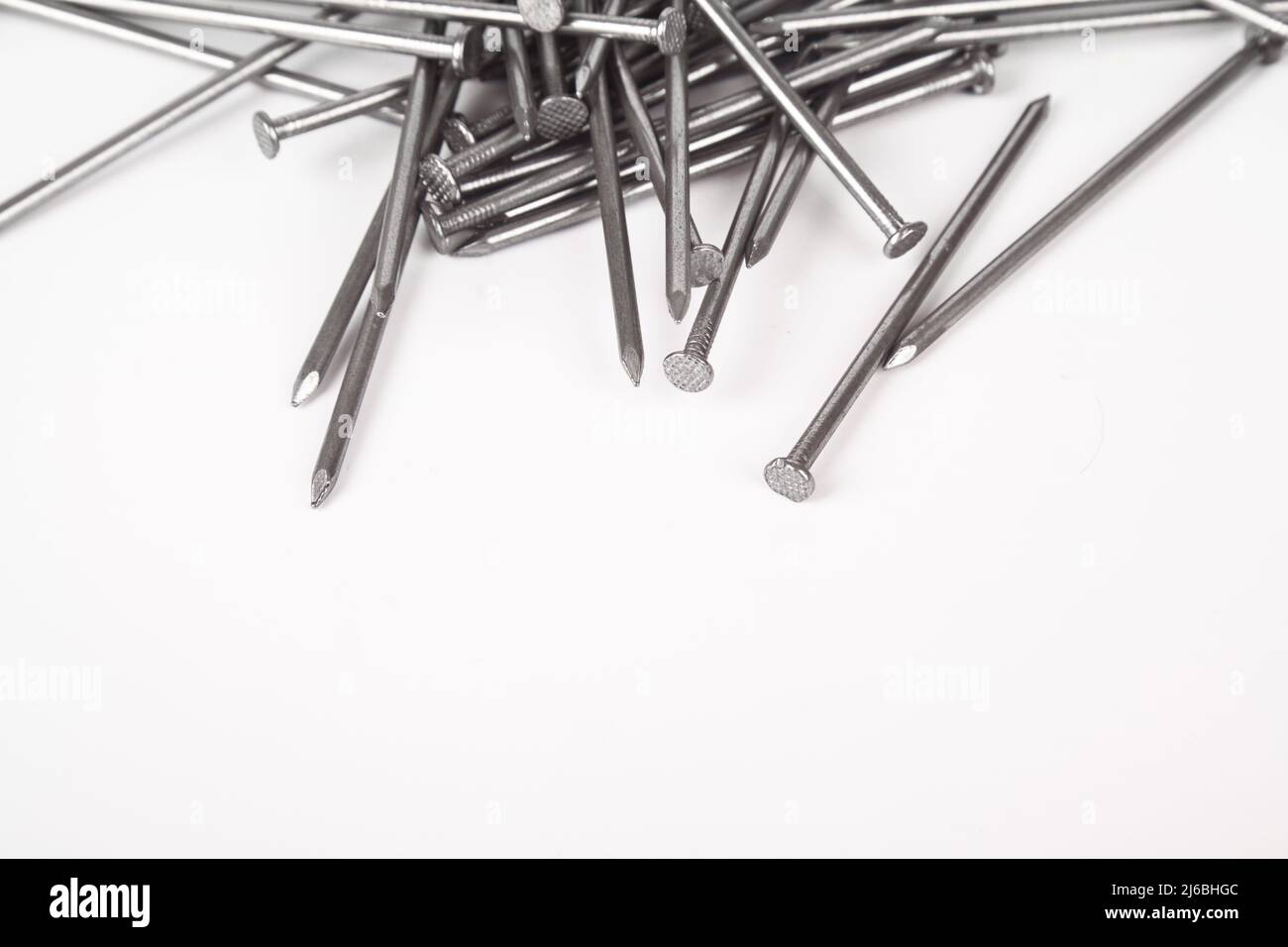 A lot of construction iron nails, industrial parts, isolated on white