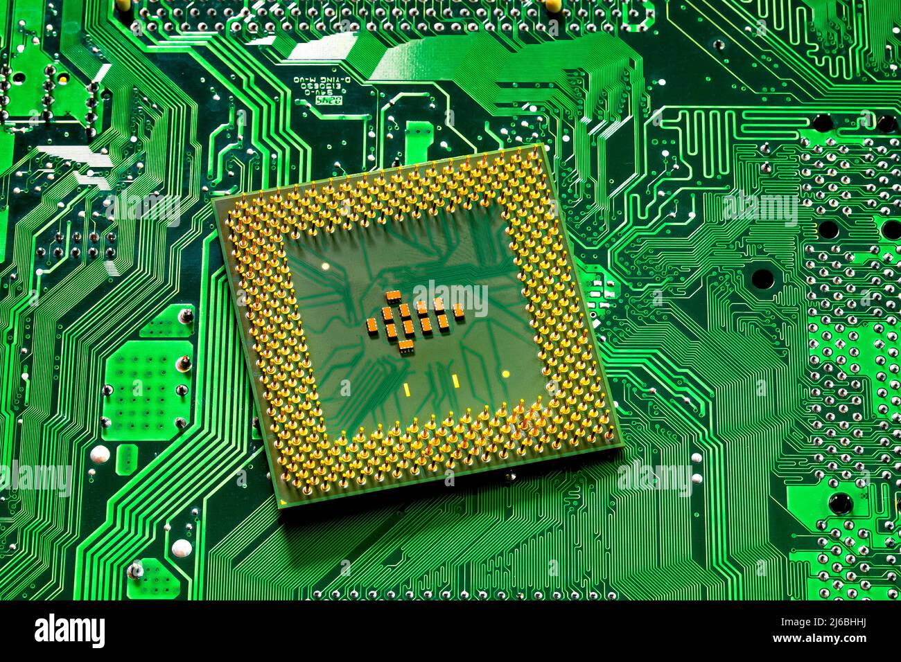 Macro Close up of microchips and pins on Main CPU PC processor circuit board. Stock Photo