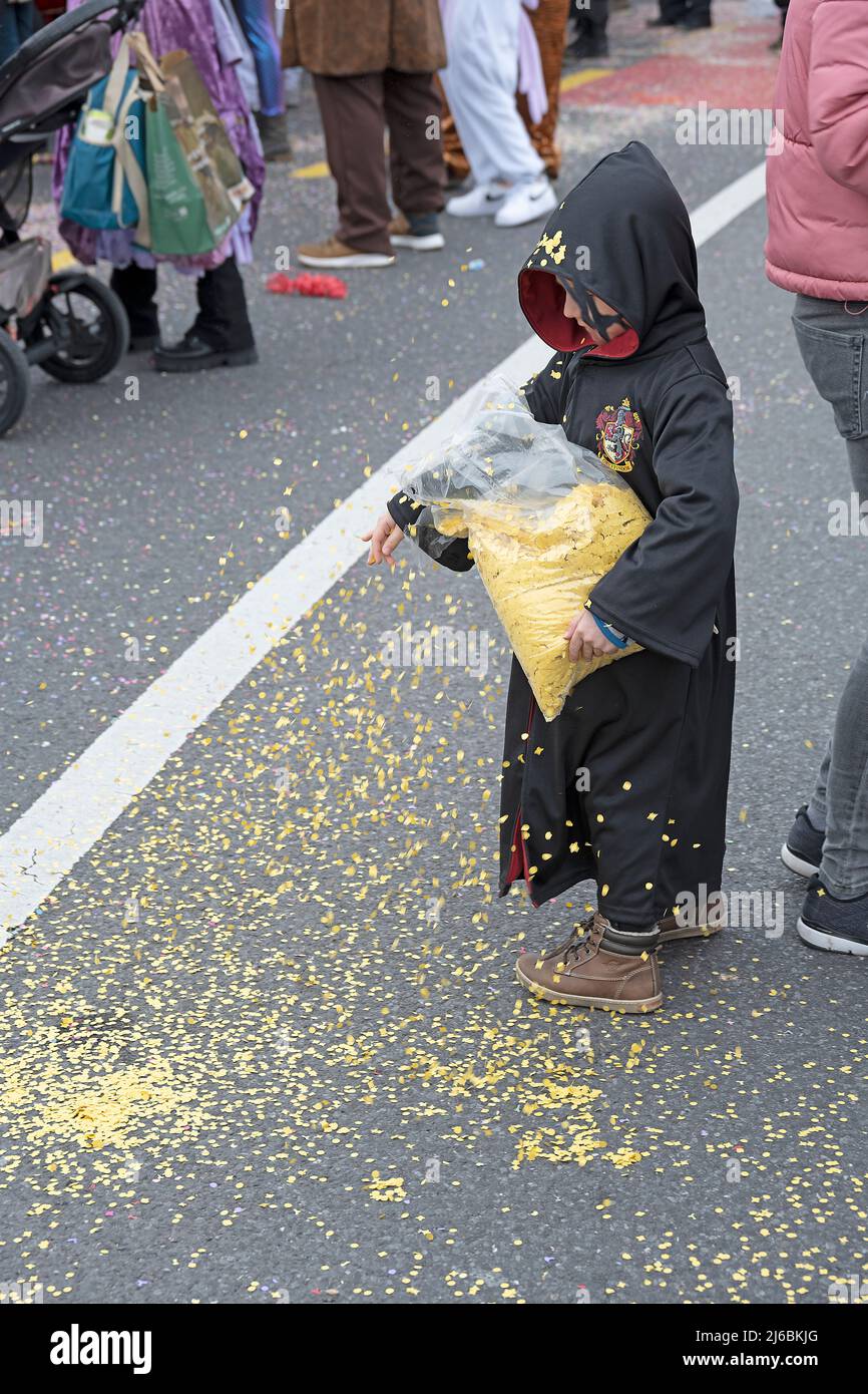 Child scatters confetti, Fasnacht, Lucerne, Switzerland Stock Photo
