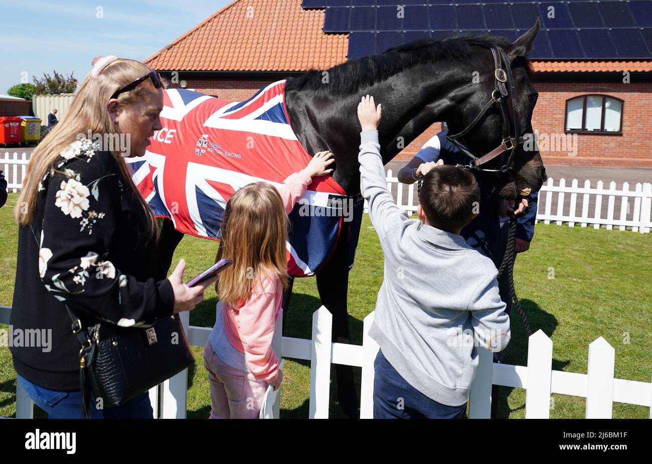 Racegoers with a Team British Racing horse on day two of the QIPCO Guineas Festival at Newmarket Racecourse, Newmarket. Picture date: Saturday April 30, 2022. Stock Photo