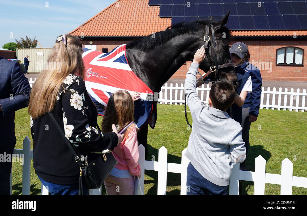 Racegoers with a Team British Racing horse in the fan zone on day two of the QIPCO Guineas Festival at Newmarket Racecourse, Newmarket. Picture date: Saturday April 30, 2022. Stock Photo