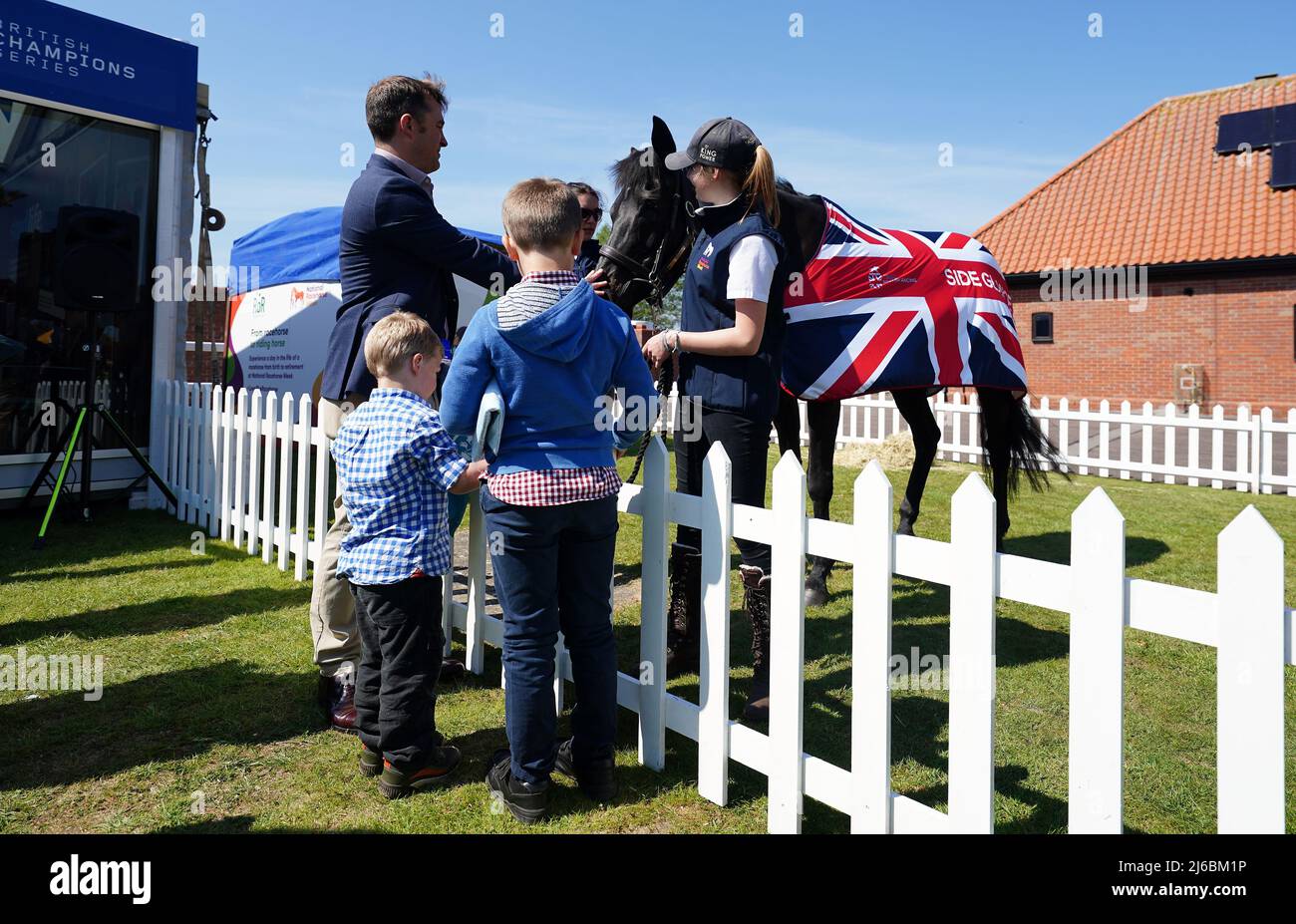 Racegoers with a Team British Racing horse in the fan zone on day two of the QIPCO Guineas Festival at Newmarket Racecourse, Newmarket. Picture date: Saturday April 30, 2022. Stock Photo