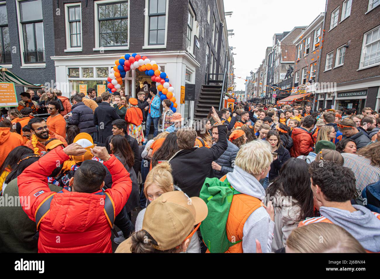 Crowds of people seen on the streets of Amsterdam during the King's Day celebration. King's Day known as Koningsdag is an orange filled celebration for the king's birthday, a national holiday full of events across the country. Thousands of local revellers and tourists visited Amsterdam to celebrate and party around the canals while wearing orange clothes and the boats doing a parade in the water canals. (Photo by Nik Oiko / SOPA Images/Sipa USA) Stock Photo