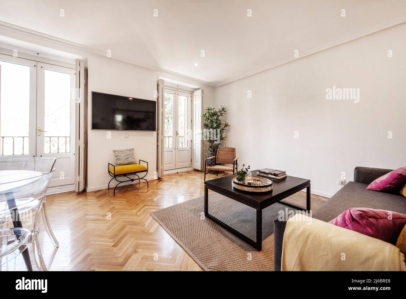 Living room with fabric sofa, dark wood side table, herringbone oak