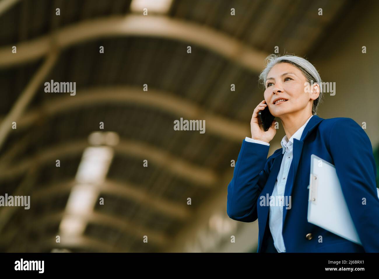 Grey asian woman walking hi-res stock photography and images - Alamy
